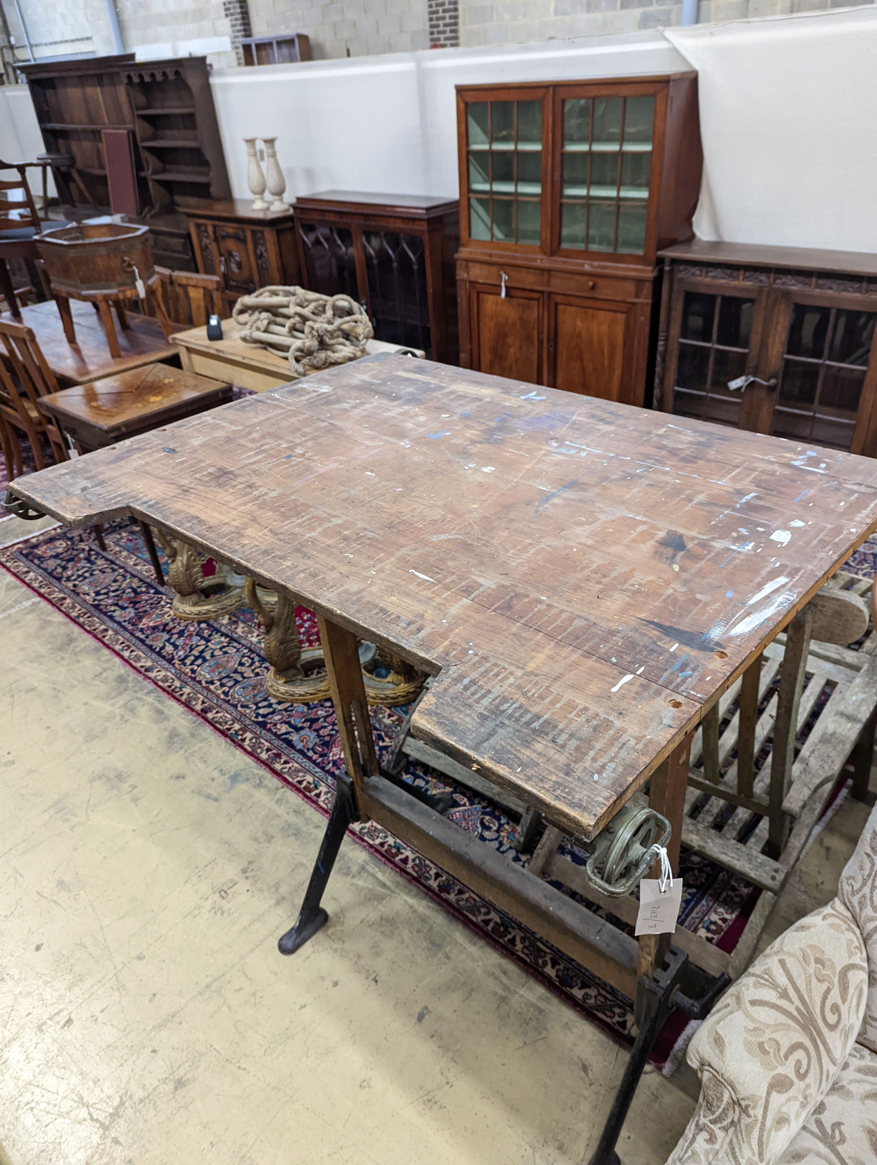 A vintage pine and cast iron draughtsman table, by R J Hall and co-Ltd Westminster W-116cm, D-95cm, H-127cm. (Table flat)